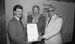 Jerry Buss receiving a plaque from Curtis Tucker, Sr., Los Angeles, 1982