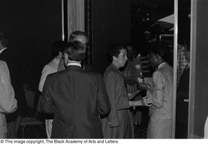 Photograph of a group of unidentified individuals walking through a doorway