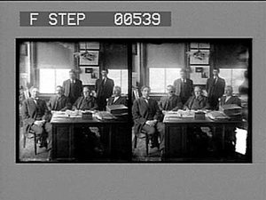 [Group portrait in office of cotton mill.] Stereo photonegative