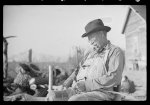 [Untitled photo, possibly related to: Mixed-breed Indian, white and Negro, near Pembroke Farms, making new chair seat. North Carolina]