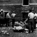 Police officers speaking to several African American men beside 16th Street Baptist Church in Birmingham, Alabama, after the building was bombed.