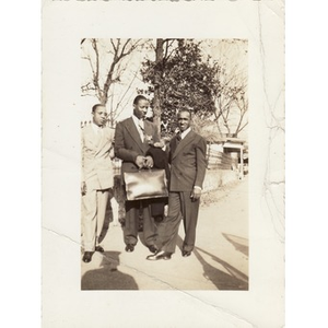 Reverend Laymon Hunter and two men in business attire