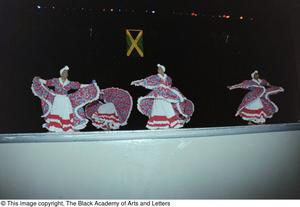 Dancers in flowing dresses during Ashe Caribbean event