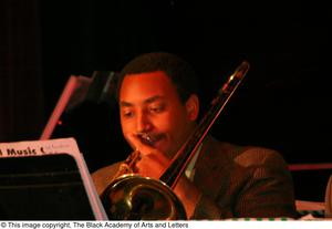 Musician playing trombone on stage