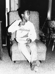 Boy in chair with bowl of chips