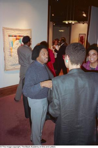 Photograph of Curtis King engaging with guests at exhibition