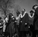 John Lewis, Ralph Abernathy, Martin Luther King Jr., Ralph Bunche, and others standing in a line on Sylvan Street in downtown Selma, Alabama, before the start of the Selma to Montgomery March.