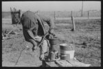 [Untitled photo, possibly related to: Children of Negro sharecropper pumping water. Family will be resettled at Transylvania Project, Louisiana]