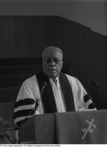 Photograph of Louie Belvet George standing at podium