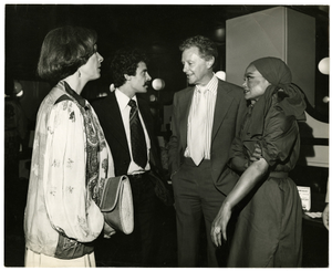 Four people talking. Woman on the right is Eartha Kitt, the man standing right next to her is Luther Davis.] [black-and-white photoprint