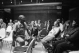 Etheridge Knight: Oxford, Miss. Knight performing at microphone in front of small audience (EKP 2-79-12/11 #295)