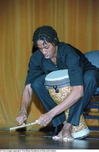 Percussionist performing at Ashe Caribbean event