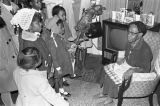 Children in the group "Buds of Promise" from Mt. Zion AME Zion Church in Montgomery, Alabama, singing to an elderly woman in her home.