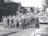 Police march down residential street after riot, Rochester, NY, 1964