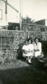 Marianne Young and Two African American Women kneeling in front of a Garden