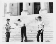 Mississippi State Sovereignty Commission photograph of Richard Barrett looking at a proclamation while an unidentified teenager holds it and another teenager looks on during a demonstration on the steps of the Mississippi State Capitol, Jackson, Mississippi, 1967 July 30