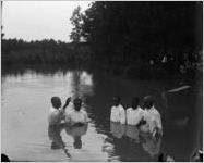 African American man is baptized.