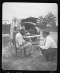 [Aunt Harriet McClention at the microphone with John A. Lomax, Sr., Mrs. Ruby Pickens Tartt, and Aunt Harriet's "great-grands" children in background, at crossroads near Sumterville, Alabama]