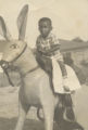 African American Boy on a Life Sized Toy Horse