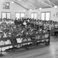 Thumbnail for Children and nuns kneeling in pews in the chapel at Nazareth Catholic Mission in Montgomery, Alabama.