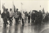 Martin Luther King, Jr., Coretta Scott King, James Bevel, and others walking in the rain during the Selma to Montgomery March.