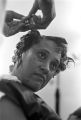 Woman having her hair put up in curlers at a beauty salon in Montgomery, Alabama.