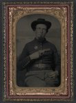 [Unidentified soldier in Union shell jacket with 7th Corps Dept. of Arkansas insignia and 1851 rectangular eagle belt plate holding volcanic pistol to his chest]