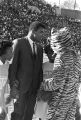 Muhammad Ali on the football field with the mascot and cheerleaders from Tuskegee Institute during homecoming activities for Alabama State College on Thanksgiving Day in Montgomery, Alabama.