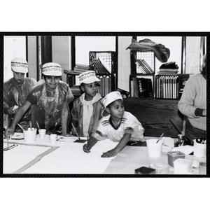 Four boys wearing hats work on projects for their art class at the Boys and Girls Clubs of Boston