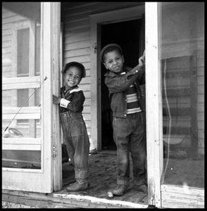 Two Children Standing in a Doorway