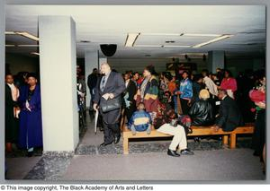 Photograph of a variety of people waiting to attend the concert