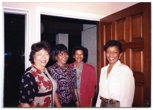 Four Smiling Women Near Door