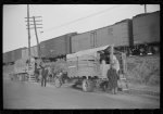 [Untitled photo, possibly related to: Day laborers being hired for cotton picking on Mississippi and Arkansas plantations. Between four and six-thirty every morning during the season, near the Hallan Bridge in Memphis, Tennessee, crowds of Negroes in the streets gather and are loaded into trucks by drivers who bid, and offer them anywhere from fifty cents to one dollar per day]