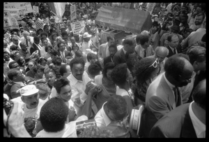 Speakers arriving at the 25th Anniversary of the March on Washington Jesse Jackson, Coretta Scott King (front center), Joseph Lowery (to right of King), and other speakers approach the stage through the crowd