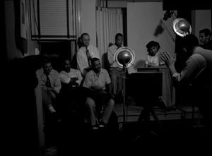 Group watching portrait photography session black-and-white acetate photonegative.