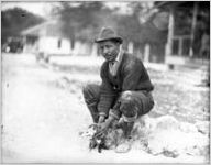 African American man holding a possum, Georgia, 1926