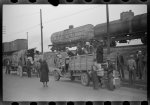 [Untitled photo, possibly related to: Day laborers being hired for cotton picking on Mississippi and Arkansas plantations. Between four and six-thirty every morning during the season, near the Hallan Bridge in Memphis, Tennessee, crowds of Negroes in the streets gather and are loaded into trucks by drivers who bid, and offer them anywhere from fifty cents to one dollar per day]