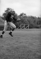 Larry Hubbard runs forward to catch the football, 1959