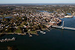 An October 2017 aerial view of the historic seaport of Portsmouth, New Hampshire, the largest city along the shortest coastline (18 miles) of any U.S. state. Portsmouth connects via the Memorial lift bridge (right) to Badger's Island, which is in Maine waters; that island, in turn connects to Kittery, the southernmost point of mainland Maine