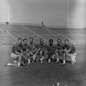 NTSU football staff kneeling