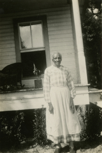 Gullah woman in front of her house