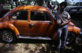 Man leaning on Volkswagen automobile