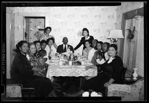 Photograph of People Sitting at a Dining Table