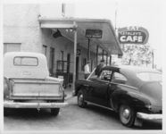 Mississippi State Sovereignty Commission photograph of taken from the side of Trailways Bus Depot and Stanley's Cafe with an unidentified male and police officer standing near the bus depot entrance, Winona, Mississippi, 1961 November 1