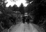 Edward Rudolph leading marchers down an unpaved road in Prattville, Alabama, during a demonstration sponsored by the Autauga County Improvement Association.