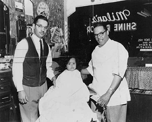 Charles Nichols, Charles Nichols, Jr. (in chair), and barber Sylvester "Chubby" Young in Chubby's Barber Shop, Sixth and Lyndale, Minneapolis