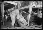 Negro stevedores handling drum, New Orleans, Louisiana