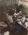 Members of the American Agriculture Movement eating barbecue at a gathering on Oscar Belvin’s farm in Montezuma, Georgia.