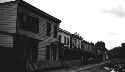 Types of Negro houses in old Jackson Ward. Row of houses owning up to the dump