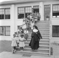 Nun lining up children on the steps in front of Nazareth Catholic Mission in Montgomery, Alabama.